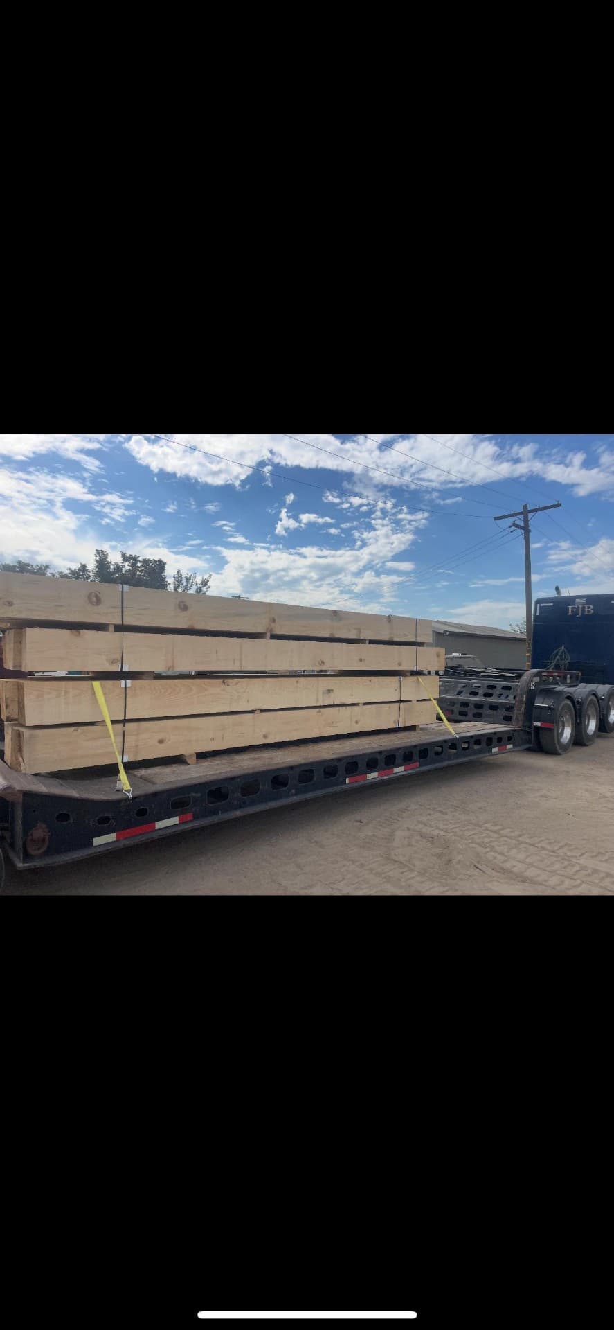 Timber posts on a flatbed trailer