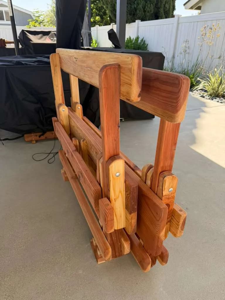Michael Frazier fold-away redwood benches stored upright on storage stands